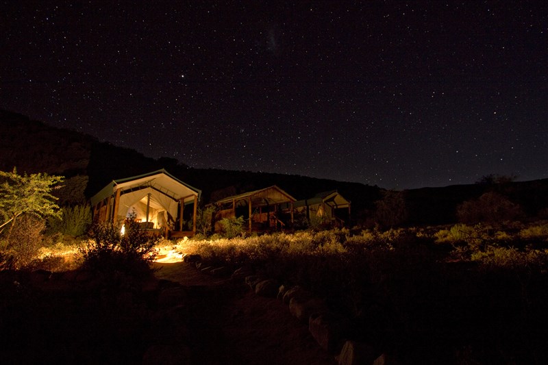 Lamplit tented suites open to a star-filled night sky